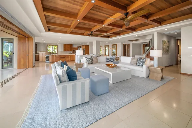 a dining room with furniture and a floor to ceiling window