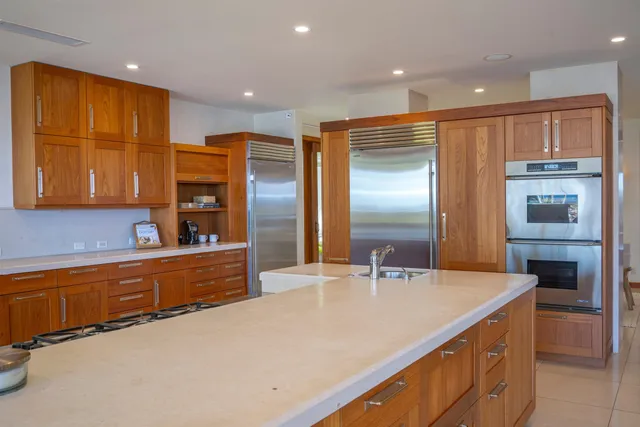 a large kitchen with stainless steel appliances lots of counter top space