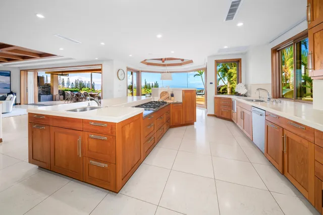 a large white kitchen with a large window