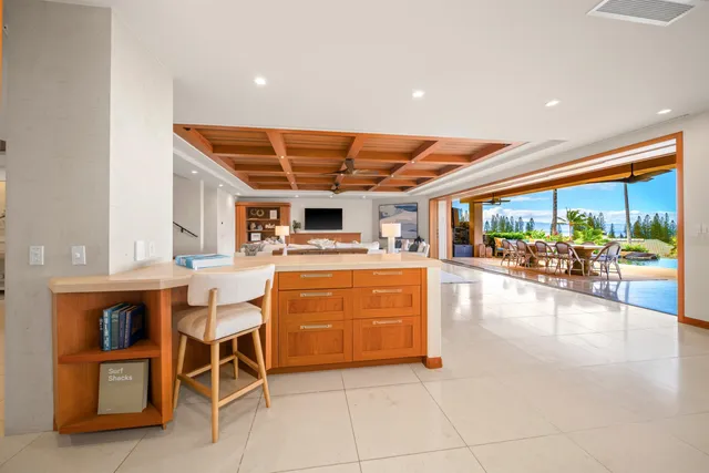 a dining hall with stainless steel appliances a dining table and chairs
