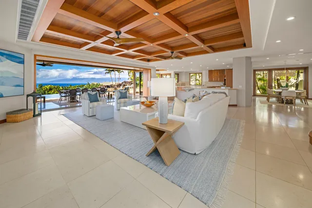 a view of a patio with dining table and chairs with wooden floor