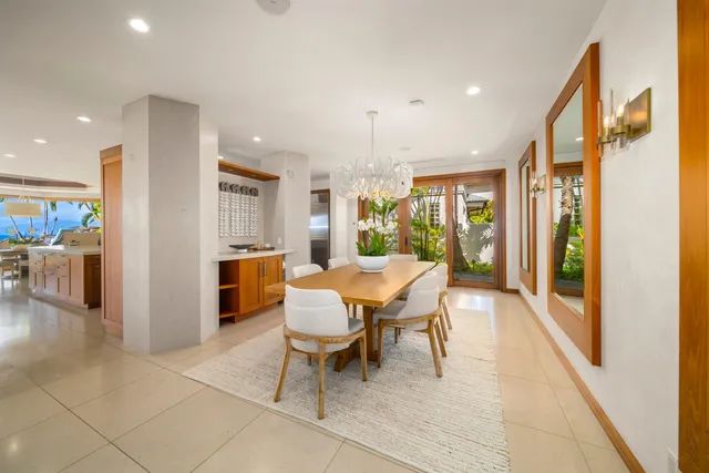 a dining hall with stainless steel appliances a dining table and chairs