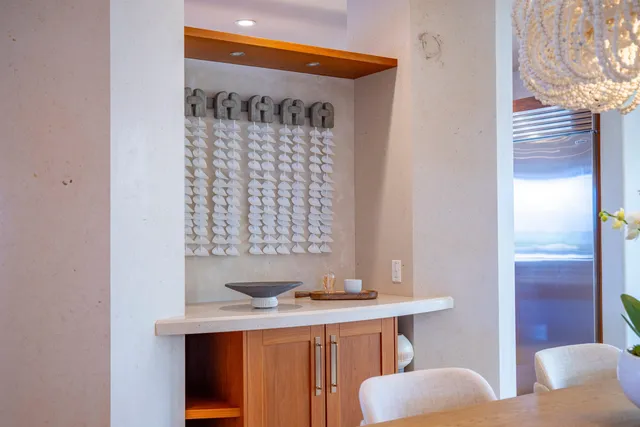 a dining room with furniture a chandelier and wooden floor