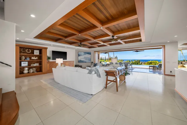 a view of a dining room with furniture water view and a floor to ceiling window