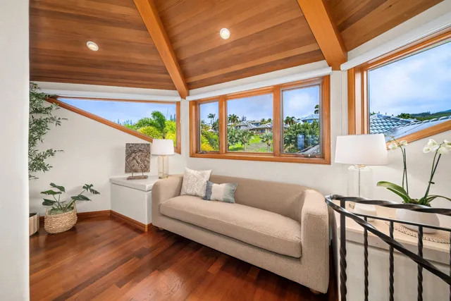 a bedroom with furniture and a large window