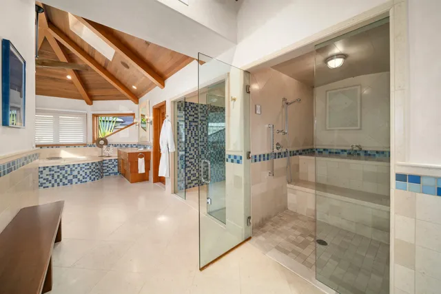 a spacious bedroom with a bed and a chandelier