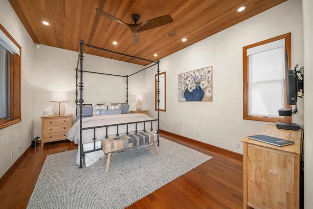 a bedroom with furniture and a flat screen tv