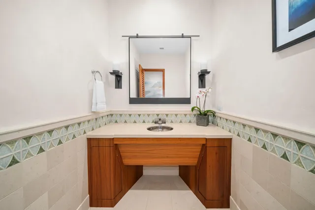 a living room with patio furniture and a view of the kitchen