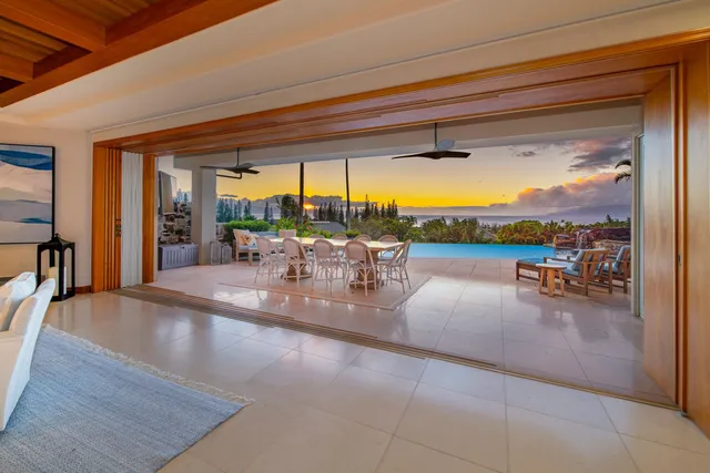 a dining room with furniture a chandelier and fireplace
