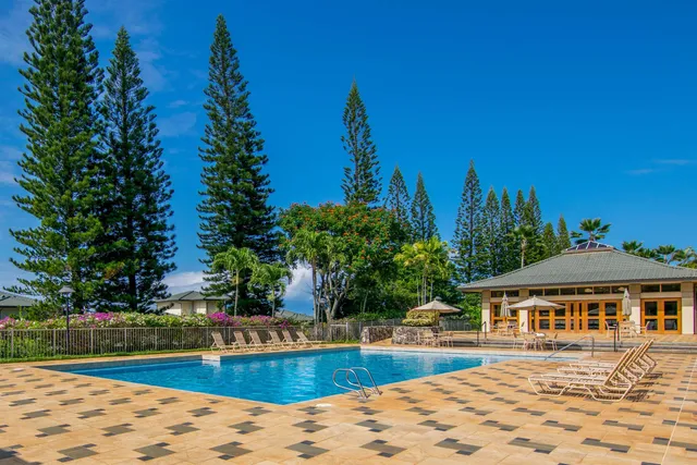 an aerial view of residential houses with outdoor space and lake view