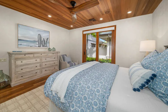 a bedroom with a large bed and dresser