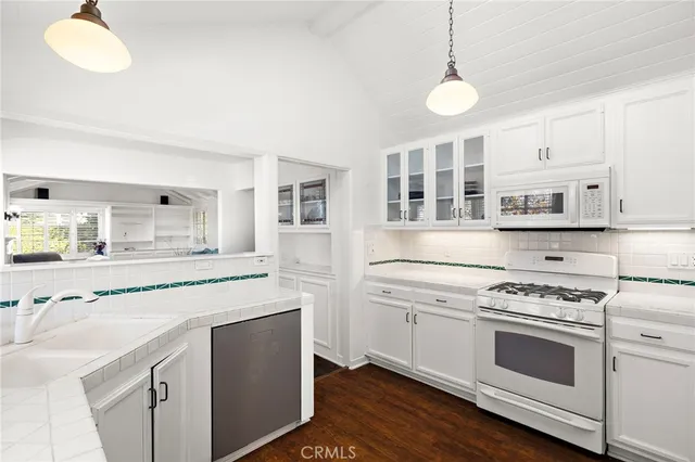 a kitchen with cabinets appliances and a center island
