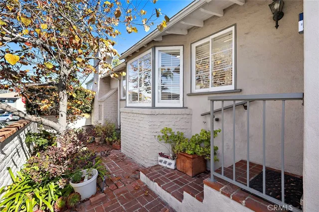 a view of a backyard with chair and potted plants