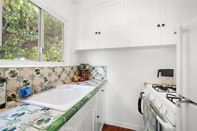 a kitchen with stainless steel appliances a stove a sink and a refrigerator