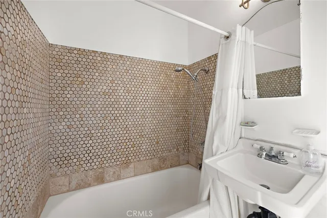 a bathroom with a bathtub and sink