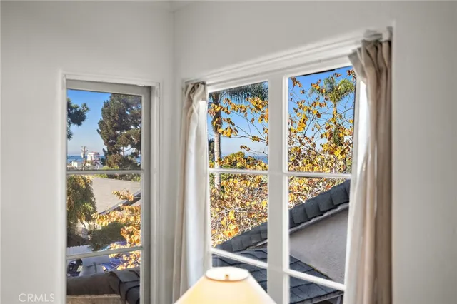 a view of a bedroom with wooden floor & a painting on the wall