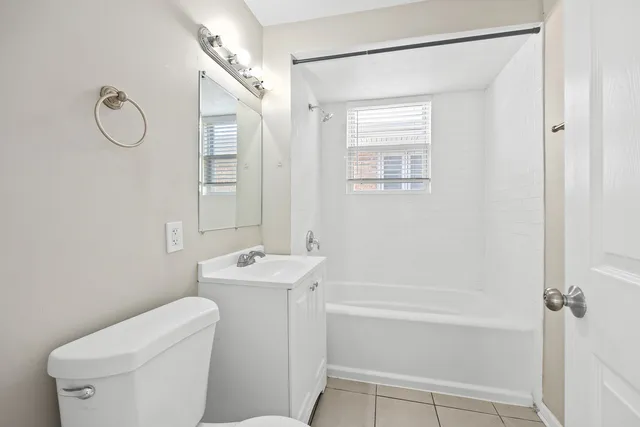 a bathroom with a shower a toilet and a sink