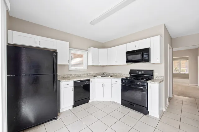 a kitchen with a refrigerator stove and microwave