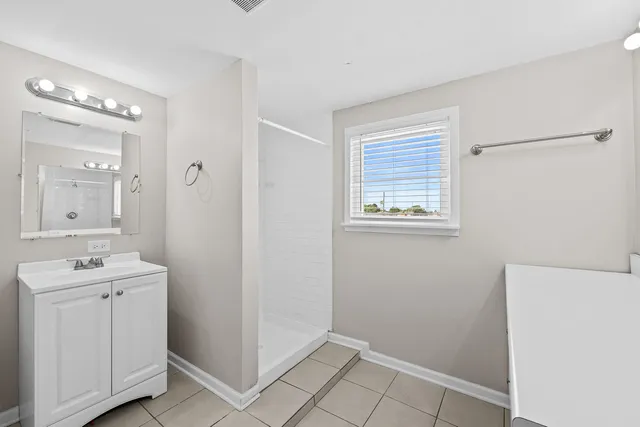 a bathroom with a sink mirror and vanity
