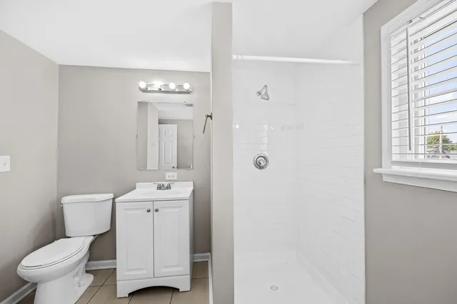 a bathroom with a toilet sink and a mirror