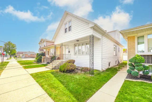 a view of a house with backyard and sitting area