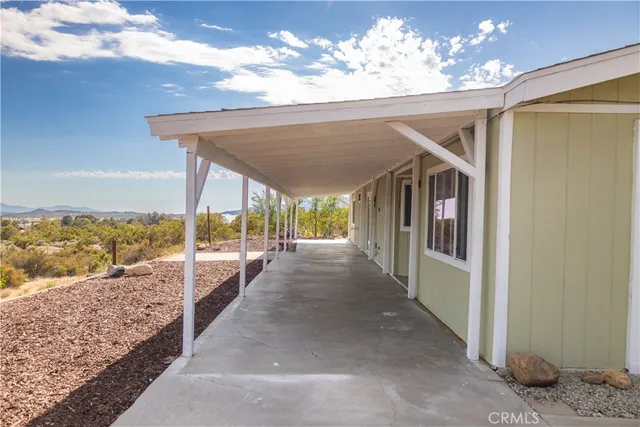 a view of a porch with furniture and floor to ceiling window