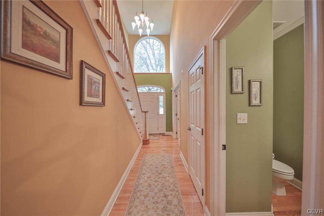 1743 Pen Argyl Road Pen Argyl, PA 18072 - Photo 12 of 38 a view of a hallway with wooden floor and a chandelier