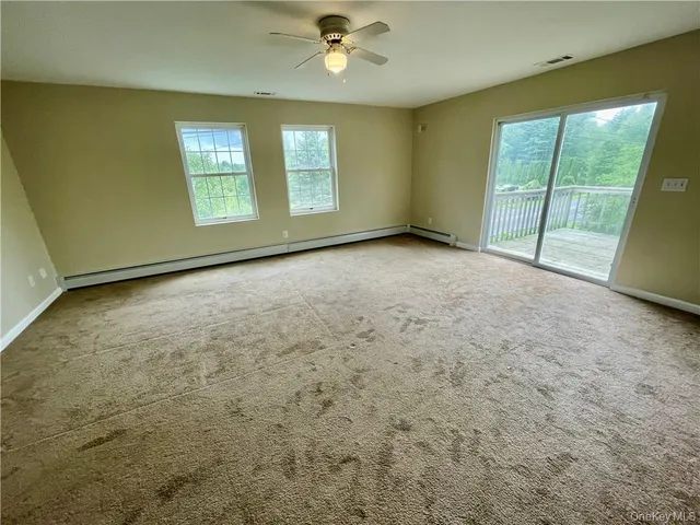 an empty room with windows and closet