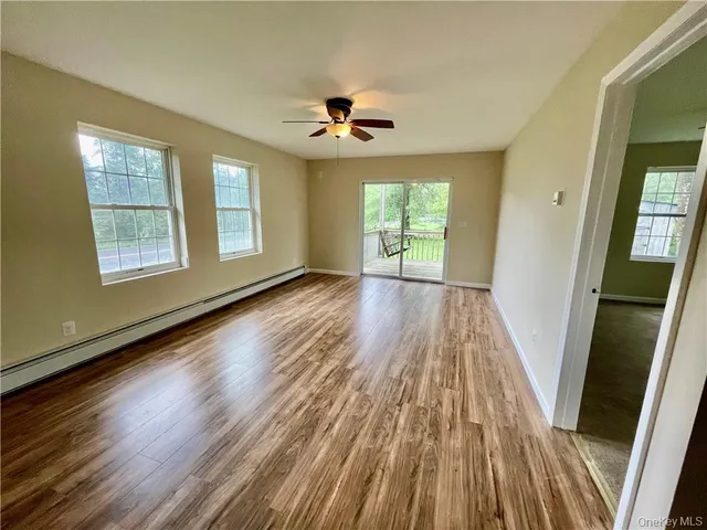 wooden floor in an empty room with a window