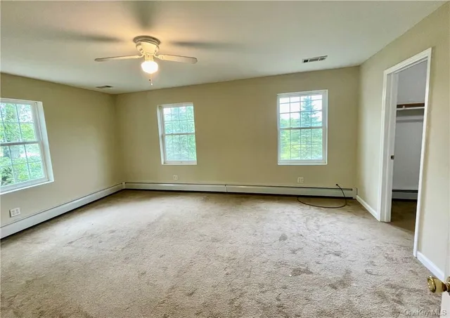 an empty room with a empty space and windows