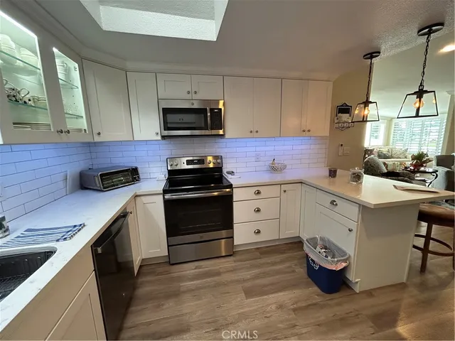 a kitchen with a sink appliances and cabinets