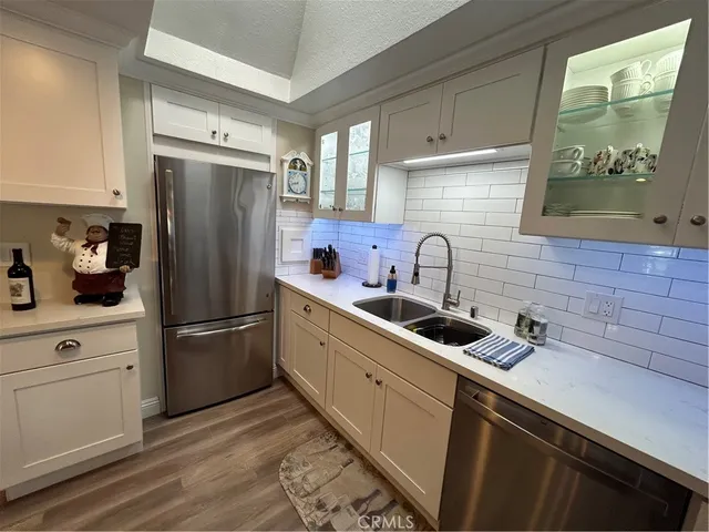 a kitchen with refrigerator a sink and cabinets
