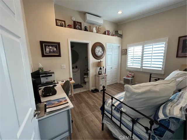 a bedroom with furniture and a chair