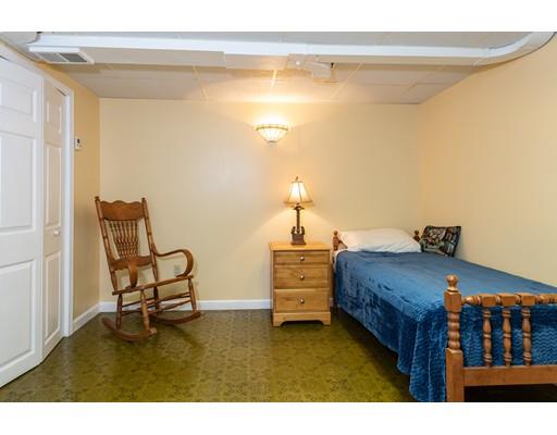 66 Audley Road Springfield, MA 01118 - Photo 20 of 30 a bedroom with a bed and a chandelier