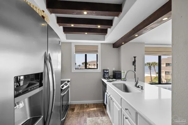 a kitchen with stainless steel appliances a sink stove and refrigerator