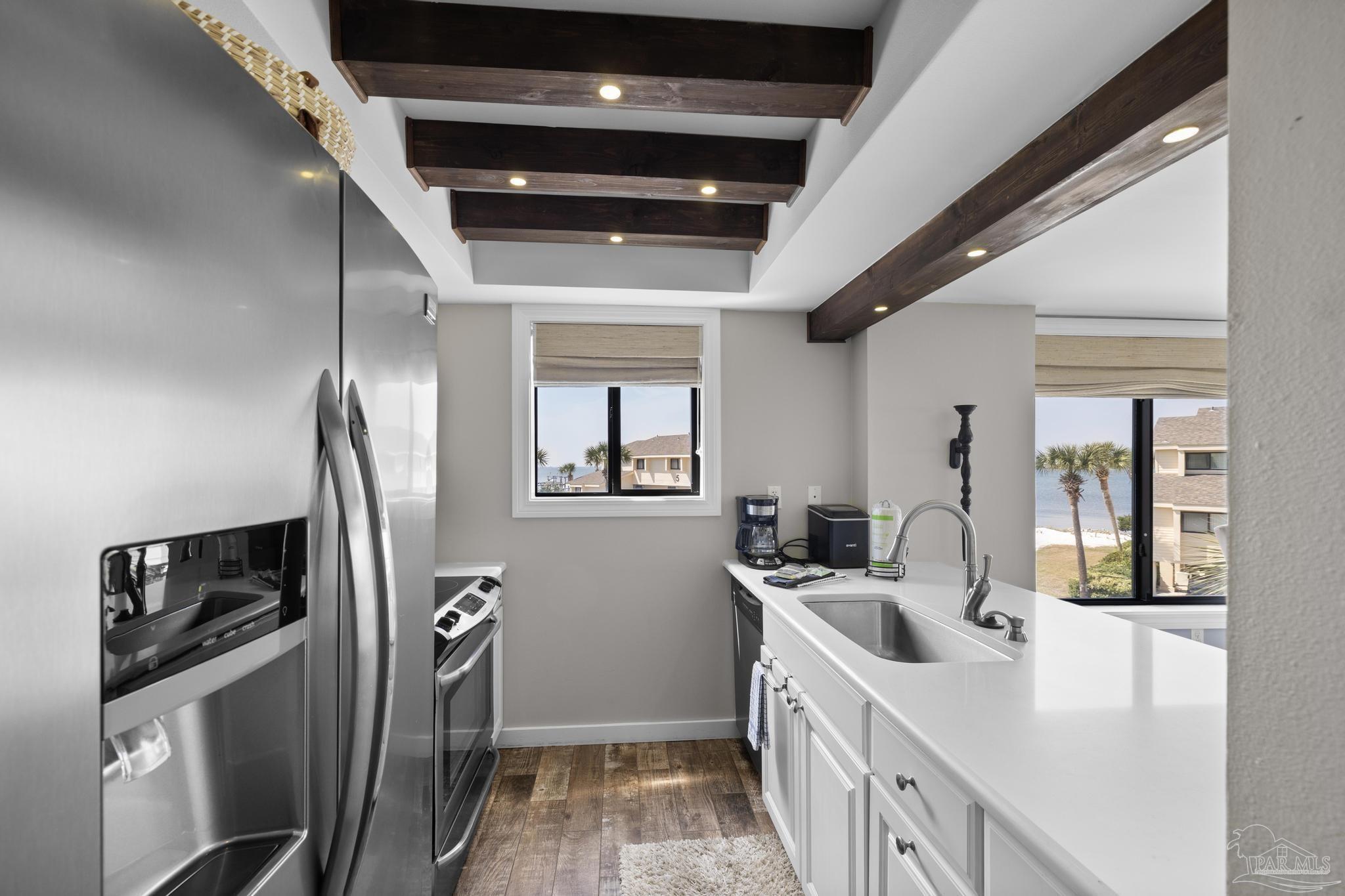 900 Fort Pickens Road, Unit 426 Pensacola Beach, FL 32561 - Photo 13 of 60 a kitchen with stainless steel appliances a sink stove and refrigerator