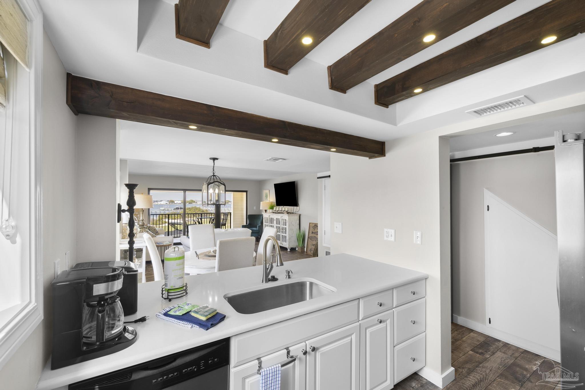 900 Fort Pickens Road, Unit 426 Pensacola Beach, FL 32561 - Photo 16 of 60 a kitchen with a sink cabinets and window