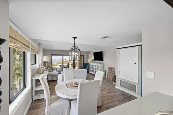 a kitchen with stainless steel appliances kitchen island granite countertop a sink a stove and white cabinets
