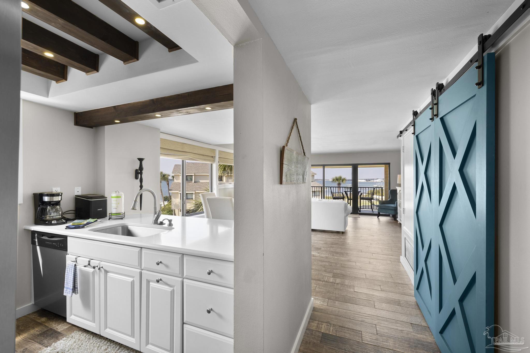 900 Fort Pickens Road, Unit 426 Pensacola Beach, FL 32561 - Photo 20 of 60 a en suite bathroom with a sink a mirror and shower