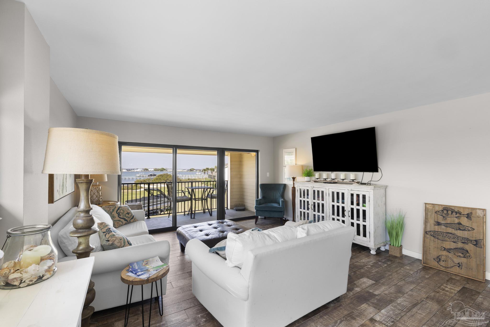 900 Fort Pickens Road, Unit 426 Pensacola Beach, FL 32561 - Photo 2 of 60 a living room with furniture and a flat screen tv