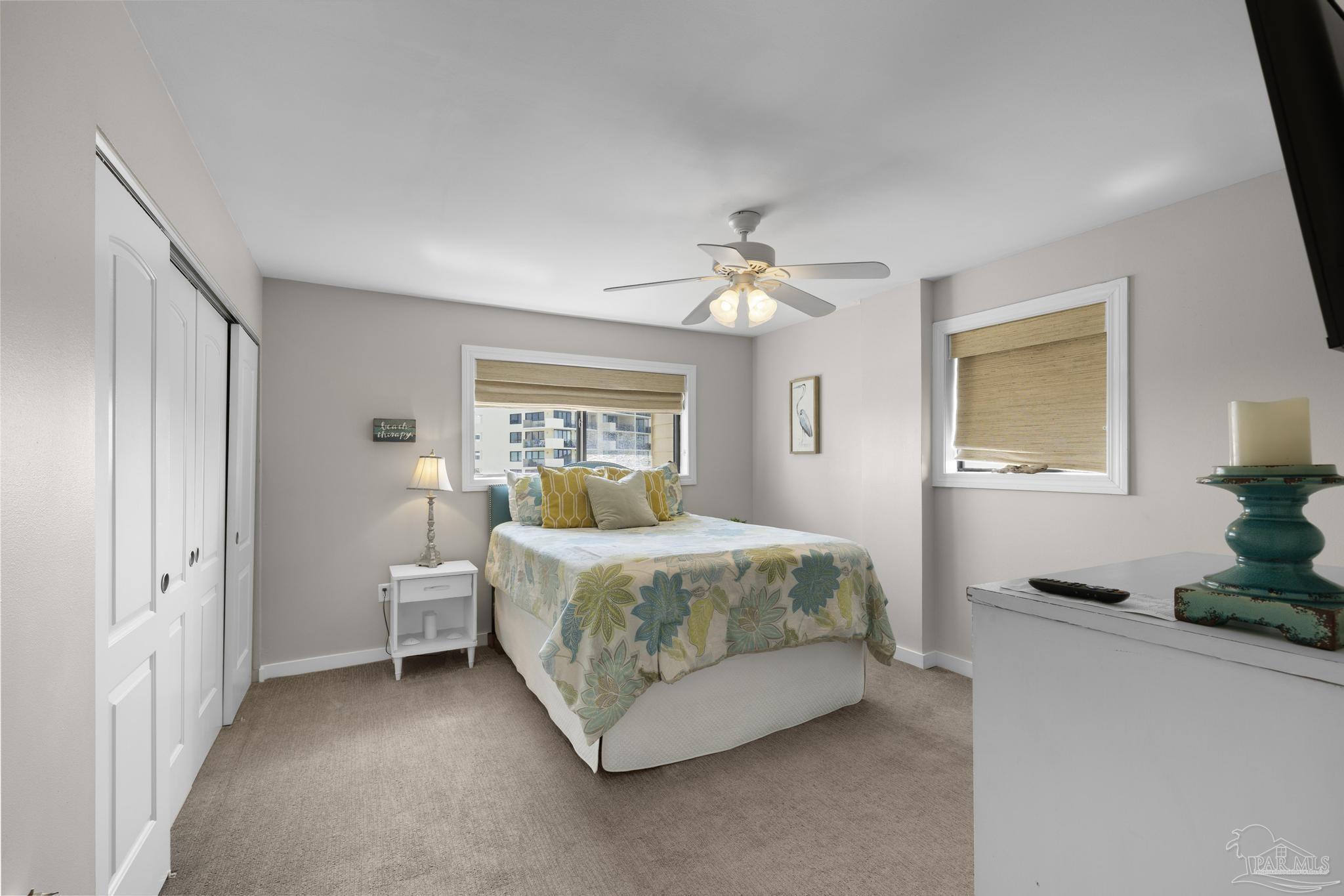 900 Fort Pickens Road, Unit 426 Pensacola Beach, FL 32561 - Photo 25 of 60 a bedroom with a bed and a chandelier