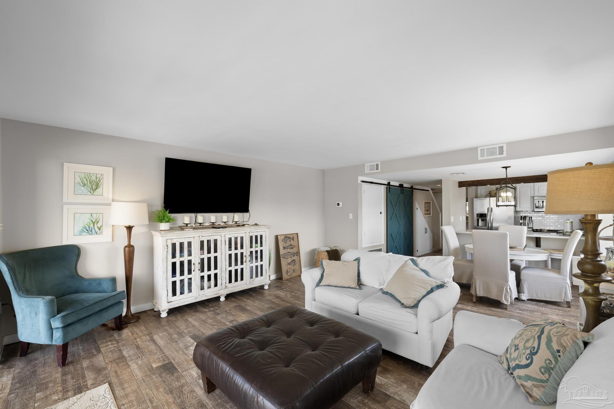 900 Fort Pickens Road, Unit 426 Pensacola Beach, FL 32561 - Photo 3 of 60 a living room with furniture and a flat screen tv