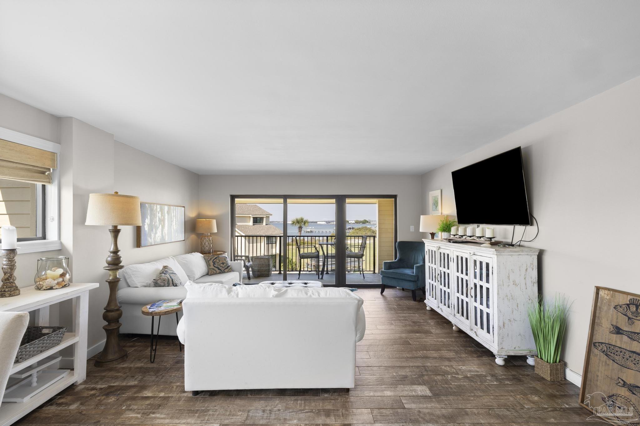 900 Fort Pickens Road, Unit 426 Pensacola Beach, FL 32561 - Photo 4 of 60 a living room with furniture and a flat screen tv
