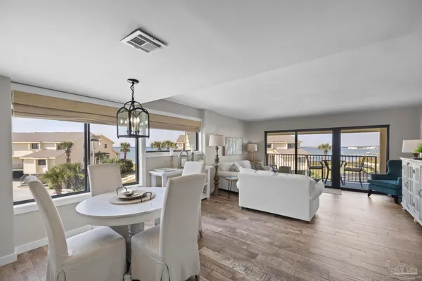 a view of a dining room with furniture wooden floor and chandelier
