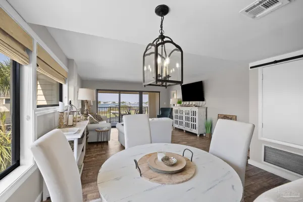 a view of a dining room with furniture window and wooden floor
