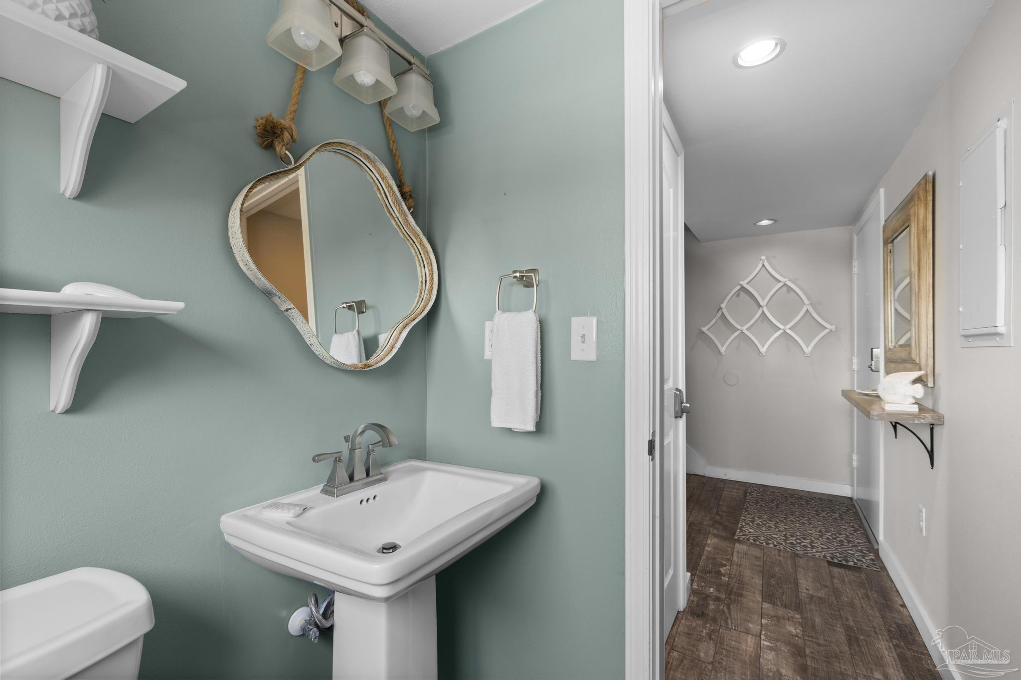 900 Fort Pickens Road, Unit 426 Pensacola Beach, FL 32561 - Photo 10 of 60 a bathroom with a sink a toilet and a mirror
