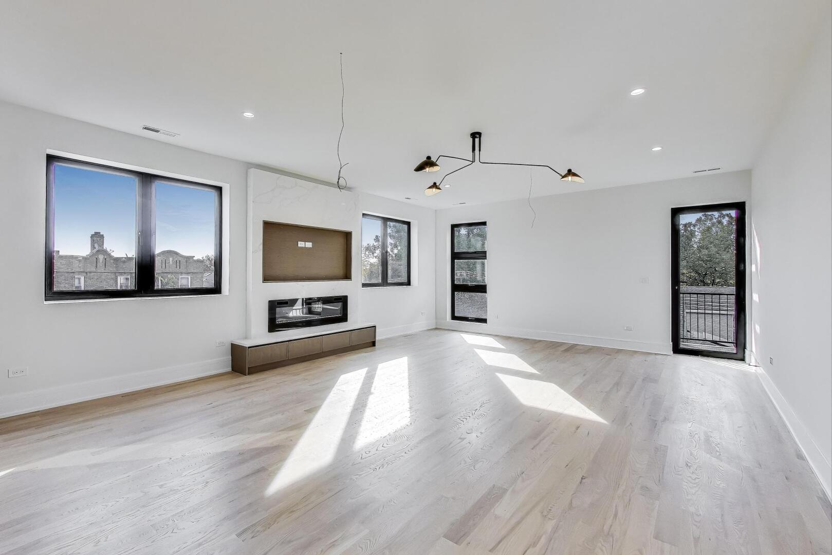 2307 West Foster Avenue, Unit 3 Chicago, IL 60625 - Photo 12 of 48 a view of a livingroom with an empty space and a window