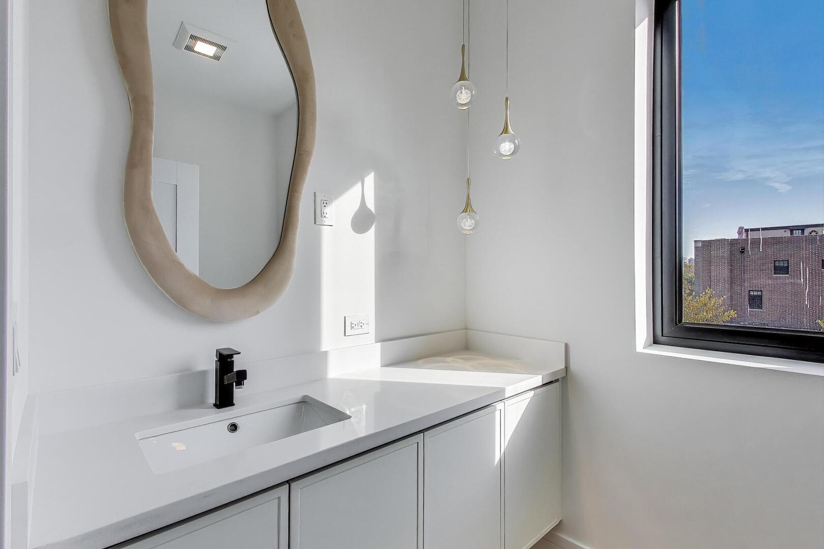 2307 West Foster Avenue, Unit 3 Chicago, IL 60625 - Photo 15 of 48 a bathroom with a sink and a mirror