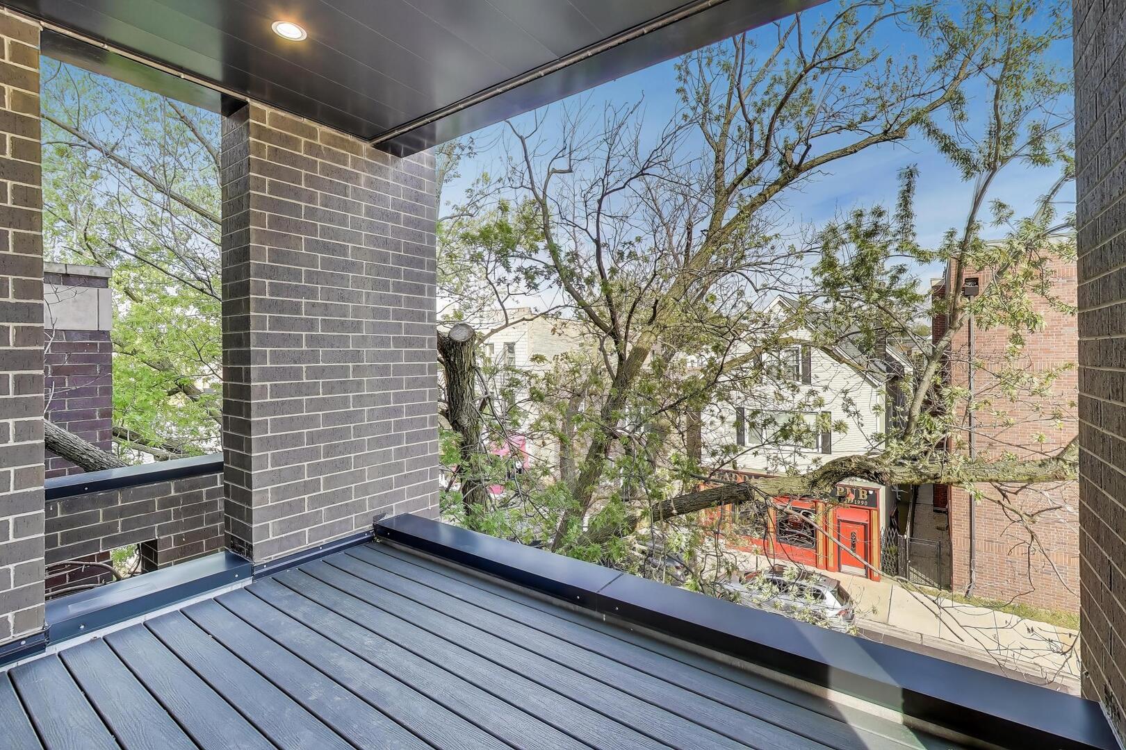 2307 West Foster Avenue, Unit 3 Chicago, IL 60625 - Photo 16 of 48 a view of a balcony with wooden floor and fence