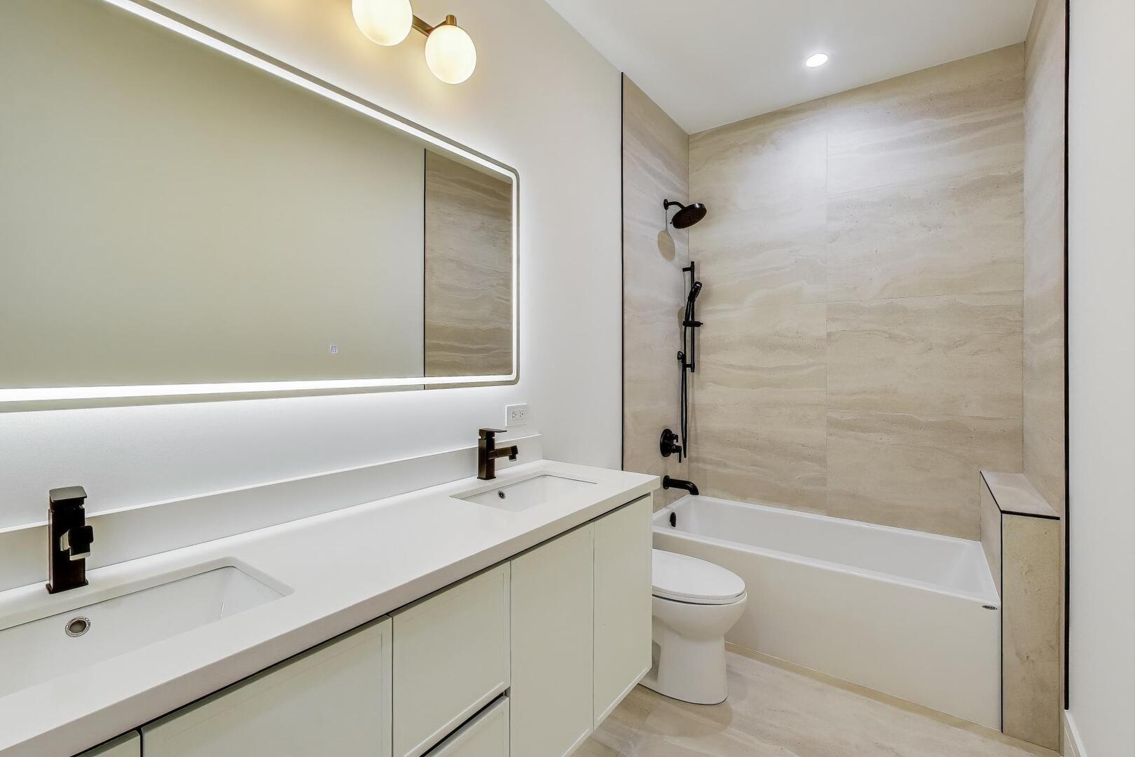 2307 West Foster Avenue, Unit 3 Chicago, IL 60625 - Photo 36 of 48 a bathroom with a sink a toilet and a bathtub